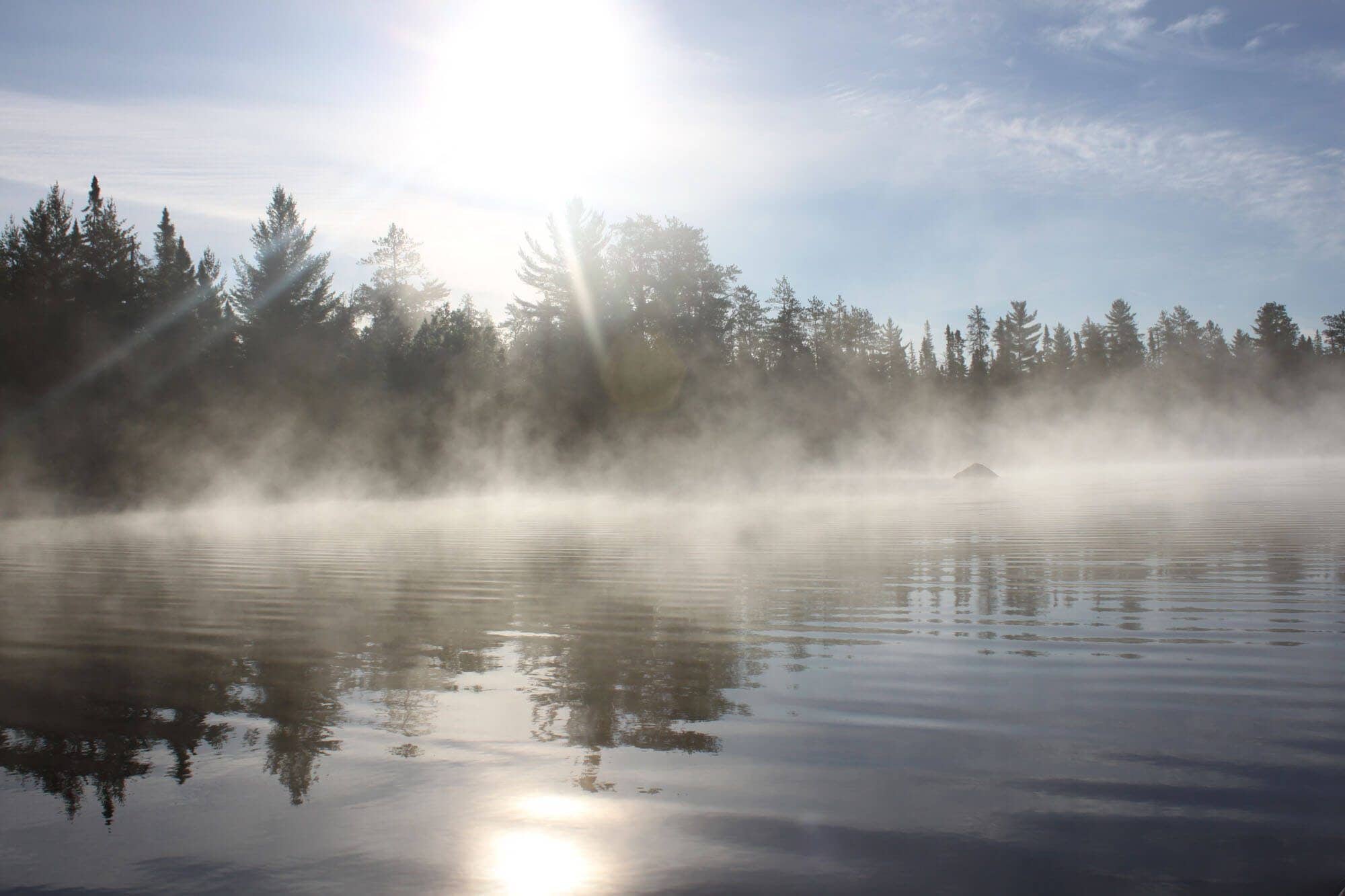 mist on the lake with sun shining through